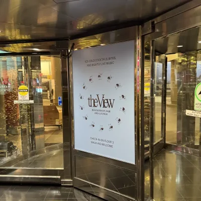 Cut vinyl graphic advertising The View restaurant, bar and lounge on glass revolving door panel, Manhattan, NY